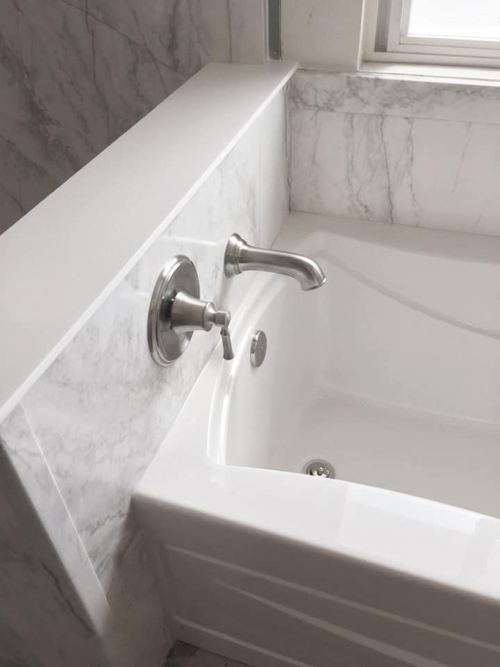 A luxurious bathroom aesthetic featuring Sentrel bath system's White Pearl marble stone pattern. 