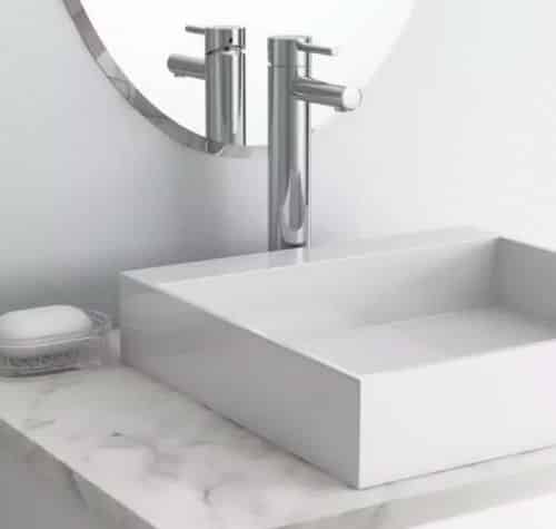 Moen brand vessel bathroom sink faucet with a square sink basin