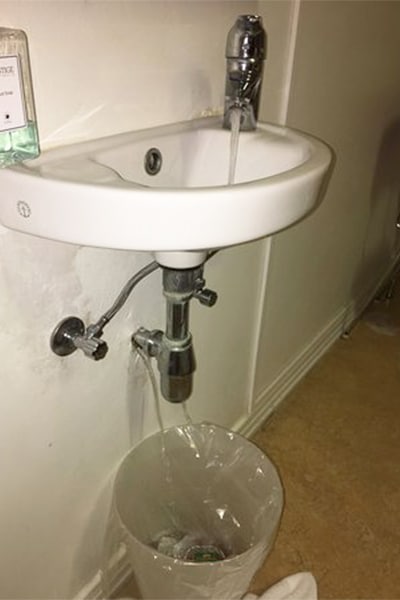DIY bathroom fixes - this sink is leaking from the pipe and from the wall.