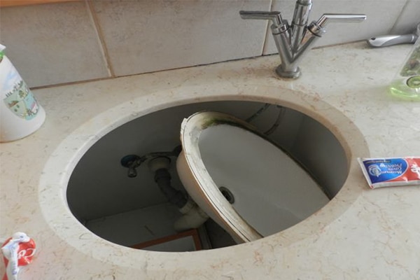 DIY bathroom fail - the sink basin fell through the hole.