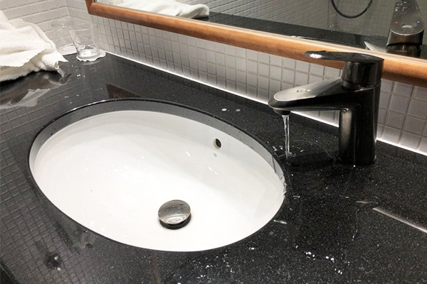Bathroom remodeling fail - DIY sink with the faucet placed an inch too far from the sink  basin. 
