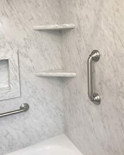 Sentrel Stone Patterns: The corer shelves of a shower, covered in Sentrel's pattern Frost. 