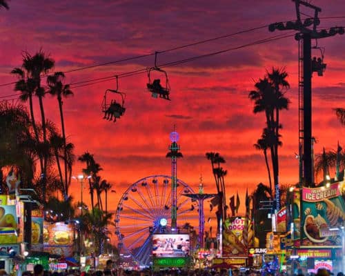 San Diego County Fair in 2019, at sunset. A silhouette of the ski lift and carnival rides. 