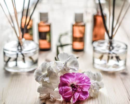 Pictured here are Flowers next to oil diffuser sticks in their jars of oil. An easy way to keep your bathroom smelling fresh. 