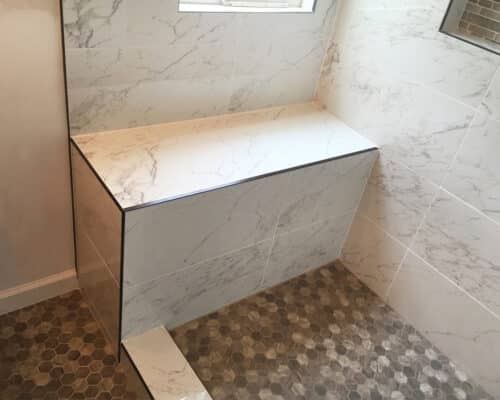 A built in shower bench made for a walk-in shower. 