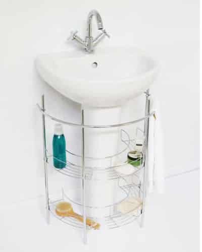 A pedestal sink with a metal rack designed to fit beneath it. The tiered rack provides storage space. 