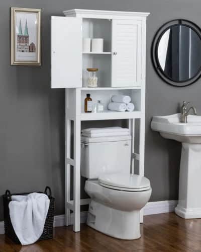 A white, wooden, over the toilet rack with a shelf and cabinet, Items are stored in the cabinet and on the shelf. 