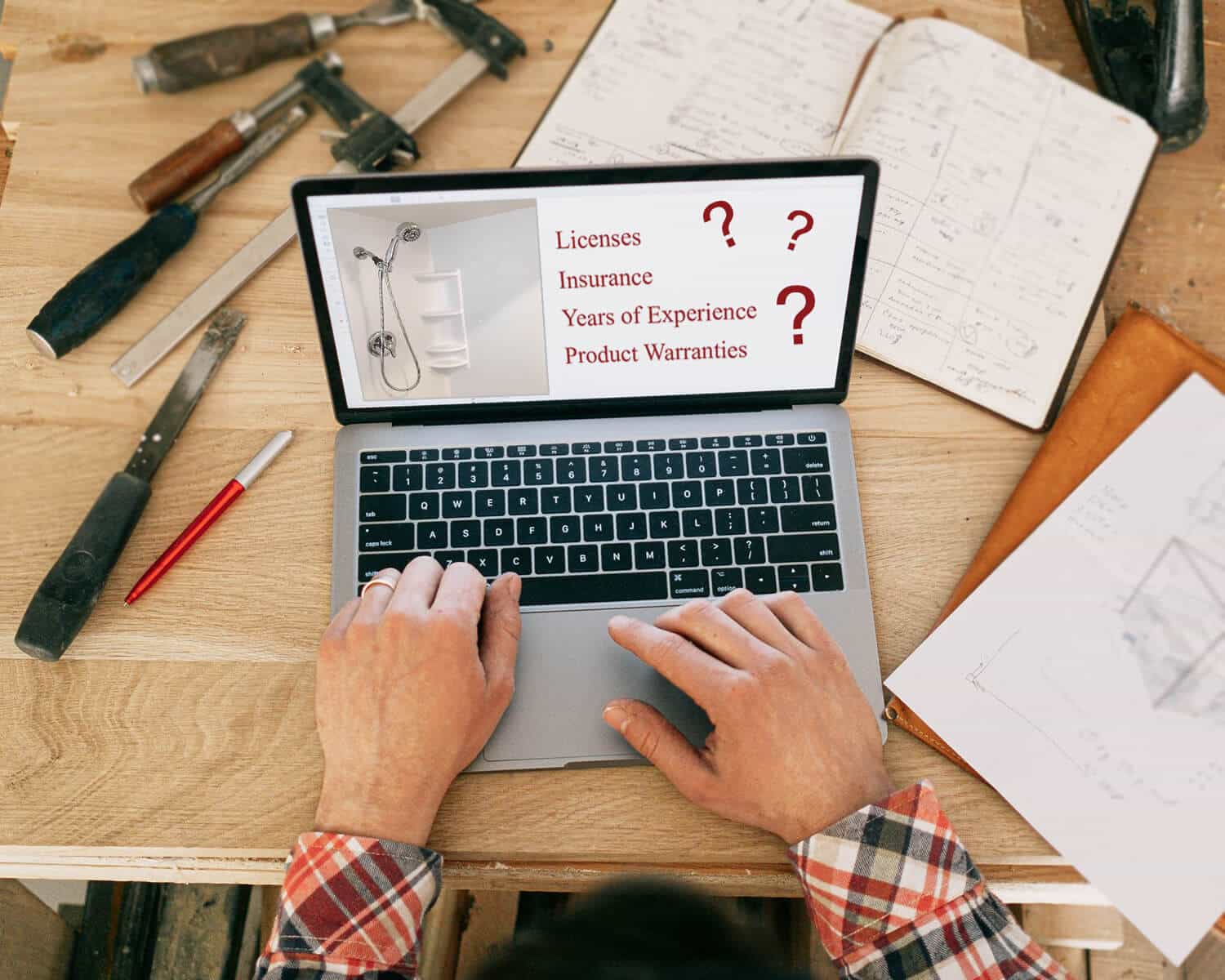 Important Questions to Ask Your Remodeler - Pictured is a laptop sitting on a wooden desk. The laptop is surrounded by written construction notes and tools.