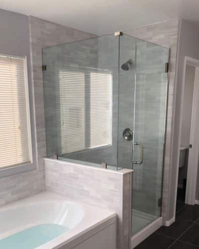 Benefits of SimTile: Veincut Grey SimTile covering shower walls and surrounding a connected bathtub.