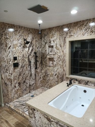 TYPES OF BATHTUBS: In this master bathroom, the walk-in shower and undermount bathtub share the walk-in shower floor.